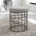 Uttermost Carnival Iron Round Accent Stool – burnished silver asymmetrical iron base with gray polyester upholstered seat