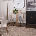 Uttermost Zelina Gold Bar Cart – hand-forged iron frame with hammered antique gold finish and clear tempered glass shelves