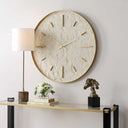Uttermost Stone Serenity Wall Clock in Light Brown – off-white stone face with antiqued gold frame