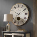 Uttermost Harrison Gray 30" Wall Clock – beige laminated face with brass center components and internal pendulum