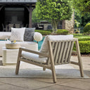 Uttermost Strapped Outdoor Lounge Chair – cerused wheat mahogany frame with taupe back straps and ivory Sunbrella cushions