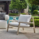 Uttermost Strapped Outdoor Lounge Chair – cerused wheat mahogany frame with taupe back straps and ivory Sunbrella cushions
