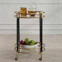 Uttermost Dolly Round Bar Cart – matte black iron with soft gold-leaf accents, two glass shelves & rolling locking casters 
